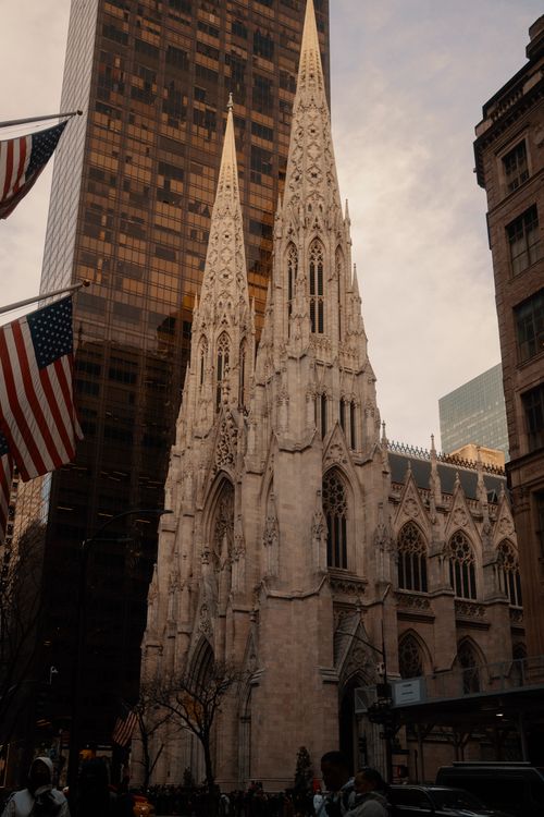 Free A stunning view of St. Patrick's Cathedral amidst New York City's skyline at day. Stock Photo