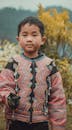 Young Boy in Traditional Tribal Attire Outdoors