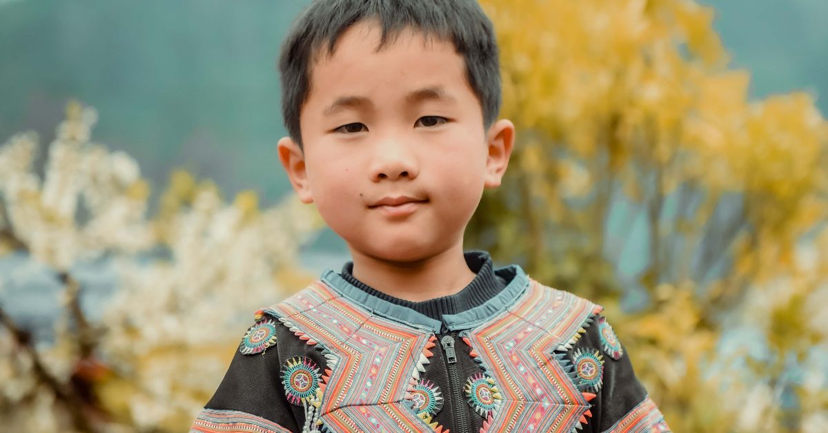 Authentic Boy Young boy wearing traditional colorful attire outdoors · Free Stock Photo