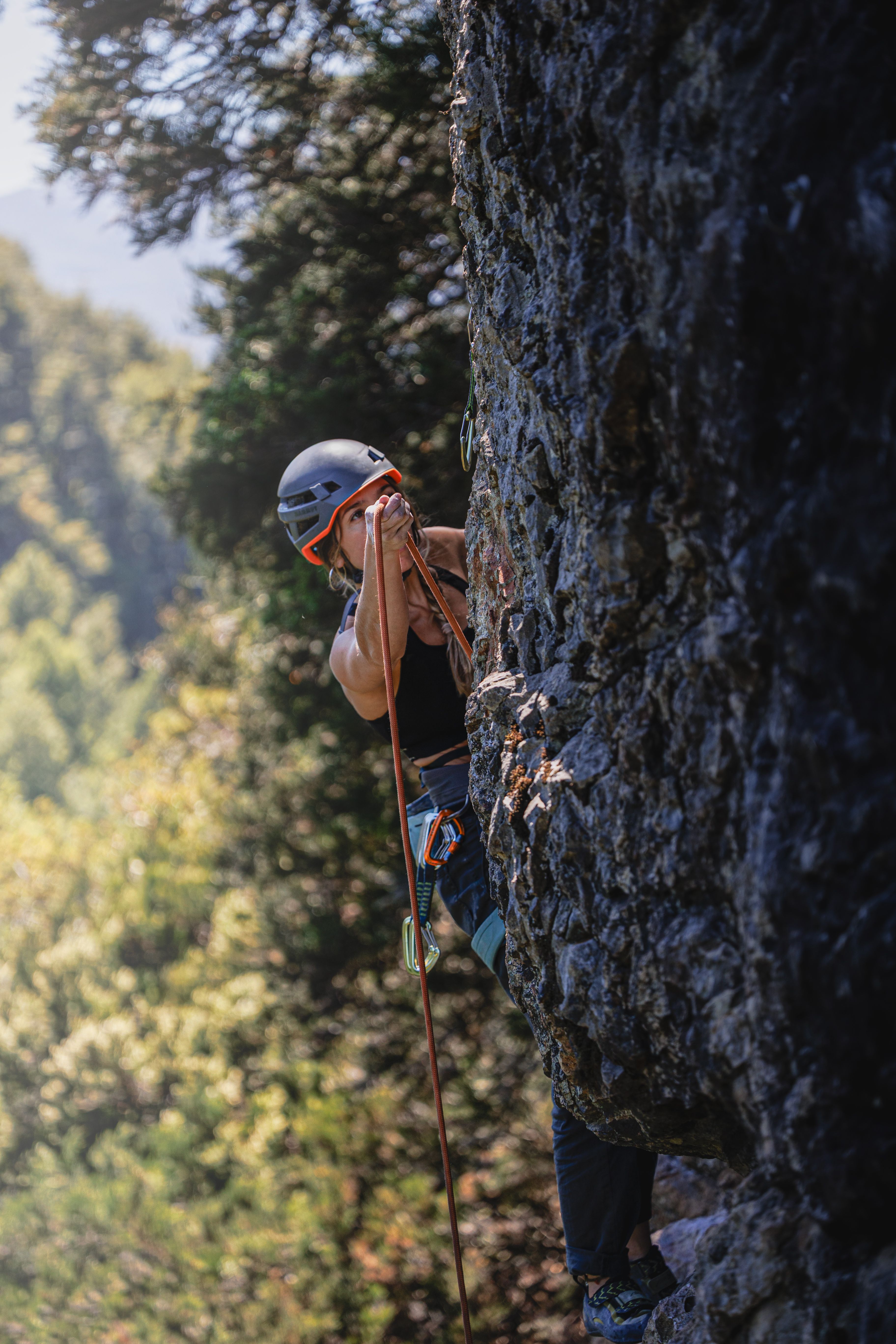 Rock climber ascending a cliff face showcasing strength and outdoor adventure