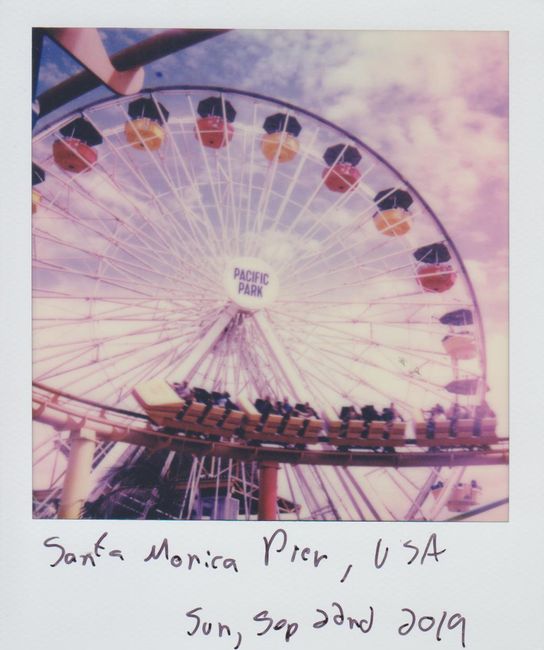 Retro-style photo capturing Pacific Park's Ferris wheel at Santa Monica Pier.