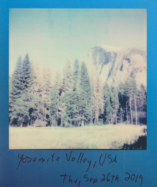 Nostalgic polaroid image of Yosemite Half Dome and coniferous trees.