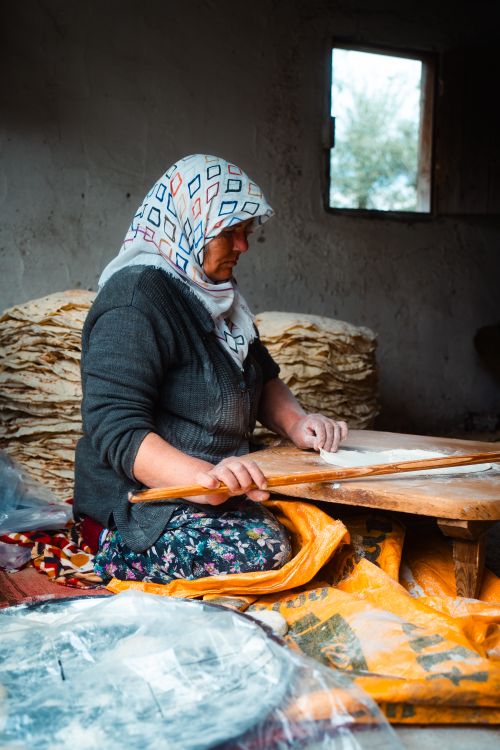 Free A woman preparing traditional bread in a rustic setting in Antalya, Turkey. Stock Photo