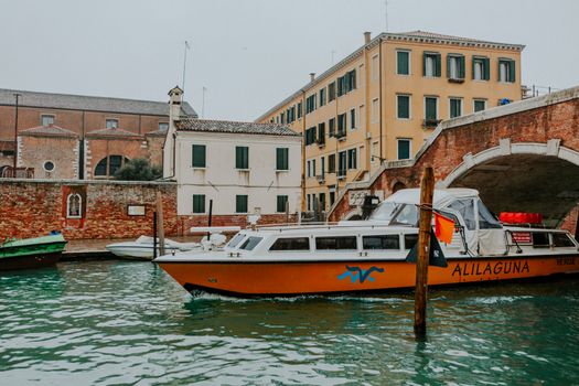 Colorful water taxi on a picturesque canal in Venice, Italy.