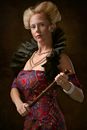 Photo of Woman Looking While Holding a Wooden Baton