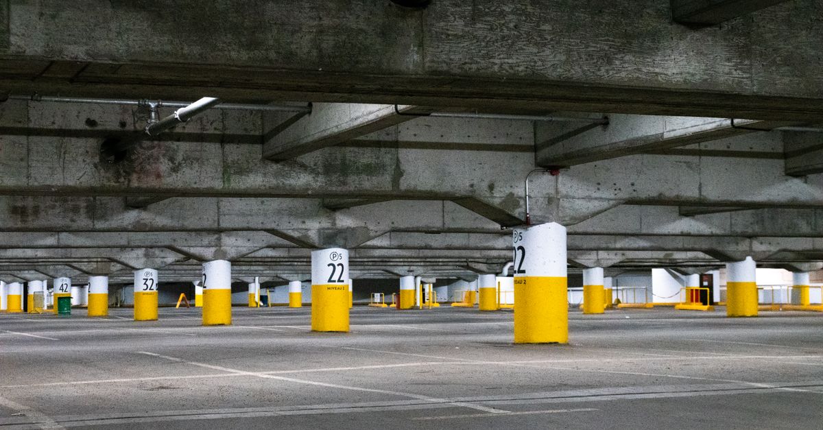 Empty underground parking lot with concrete pillars in Montreal, Canada.