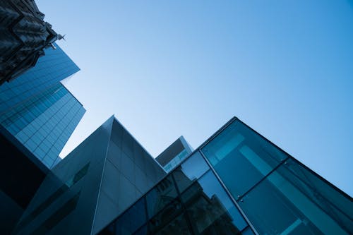 High Rise Buildings With Glass Windows Under Blue Sky