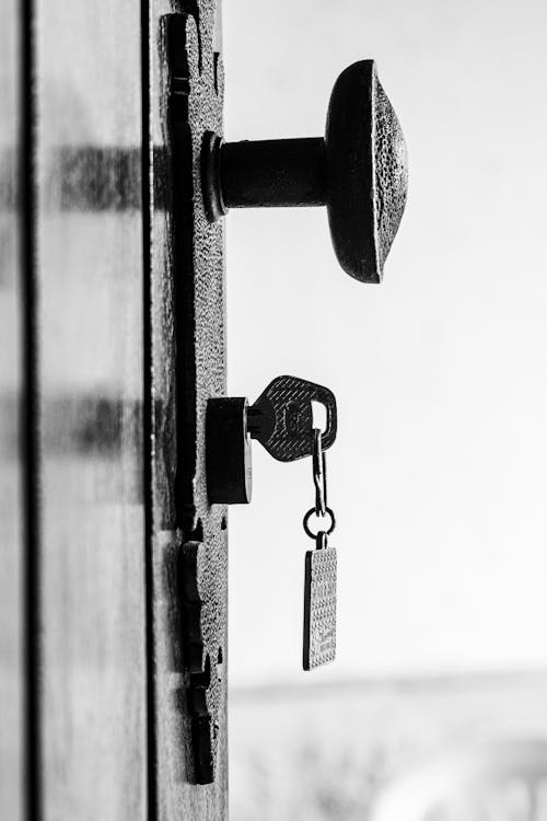 Vintage Key in Lock on Rustic Door · Free Stock Photo