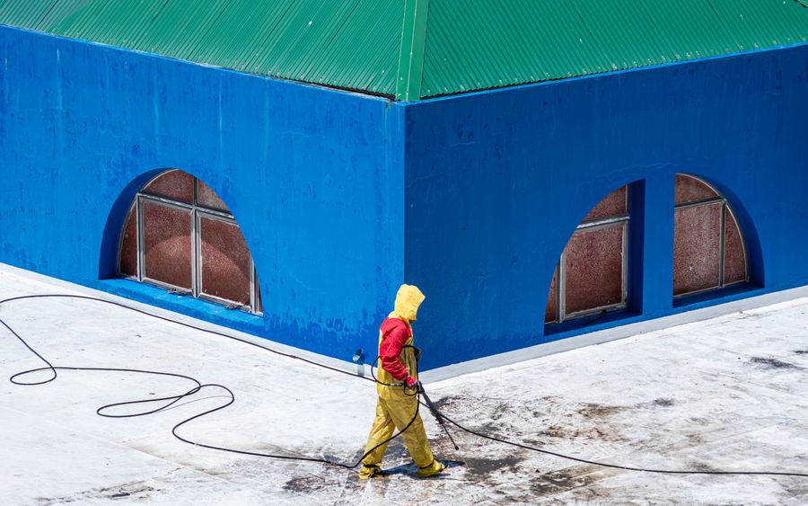 Pressure washing a building exterior