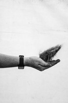 Black and white photo of a hand with sand falling, captured in Argentina.
