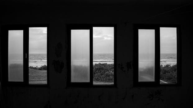 Black and white ocean view framed by windows in La Lucila del Mar.