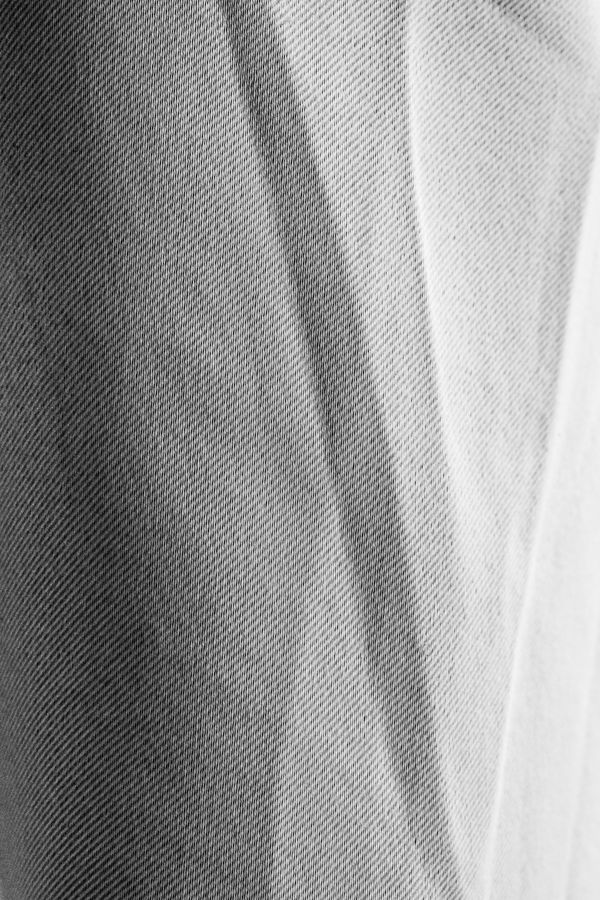 Vertical folds of a pale curtain — Alex Dos Santos on Pexels