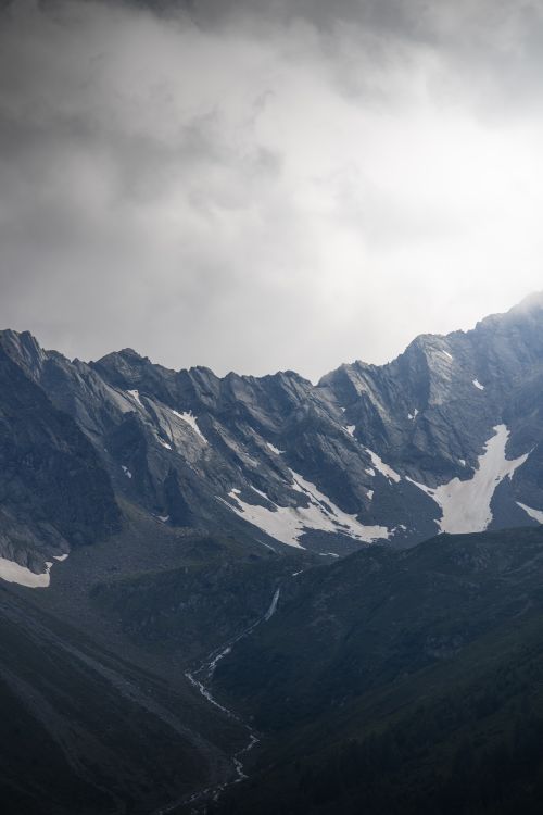 Free Explore the captivating alpine landscape of Längenfeld, Tirol, with dramatic mountains and cloudy skies. Stock Photo