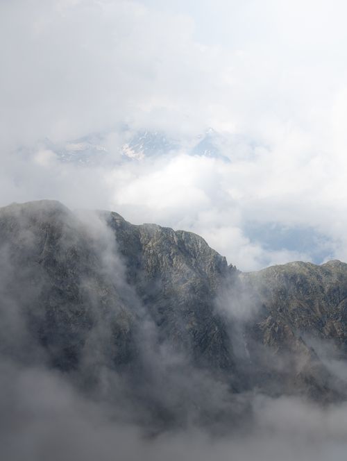 Free A foggy and mystical view of the mountain peaks in Oetz, Tirol, Austria, enveloped in clouds. Stock Photo