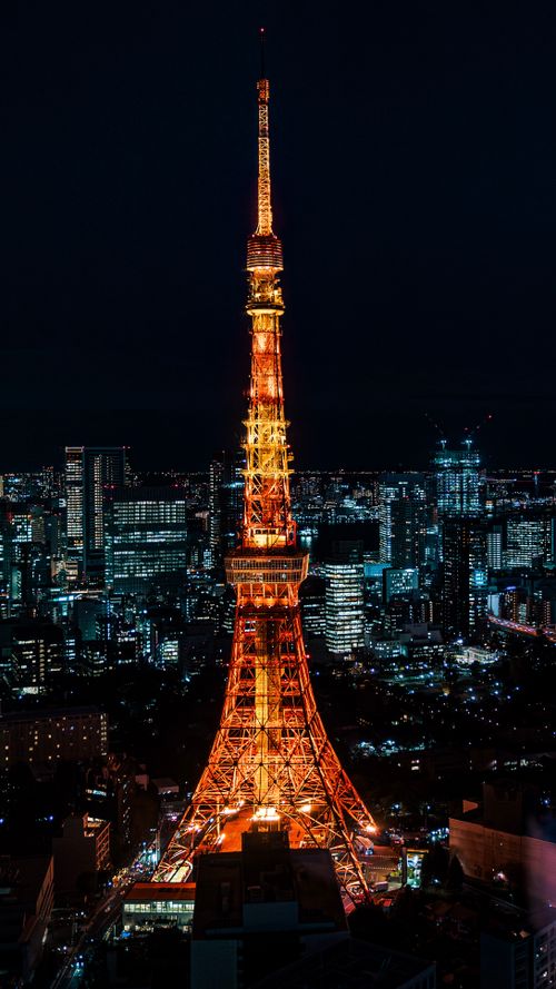 Free Dazzling Tokyo Tower at night with city skyline in vibrant lights. Stock Photo