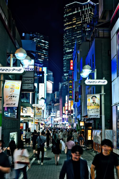 Free Vibrant night scene in Shibuya, Tokyo with bustling crowds and neon lights. Stock Photo