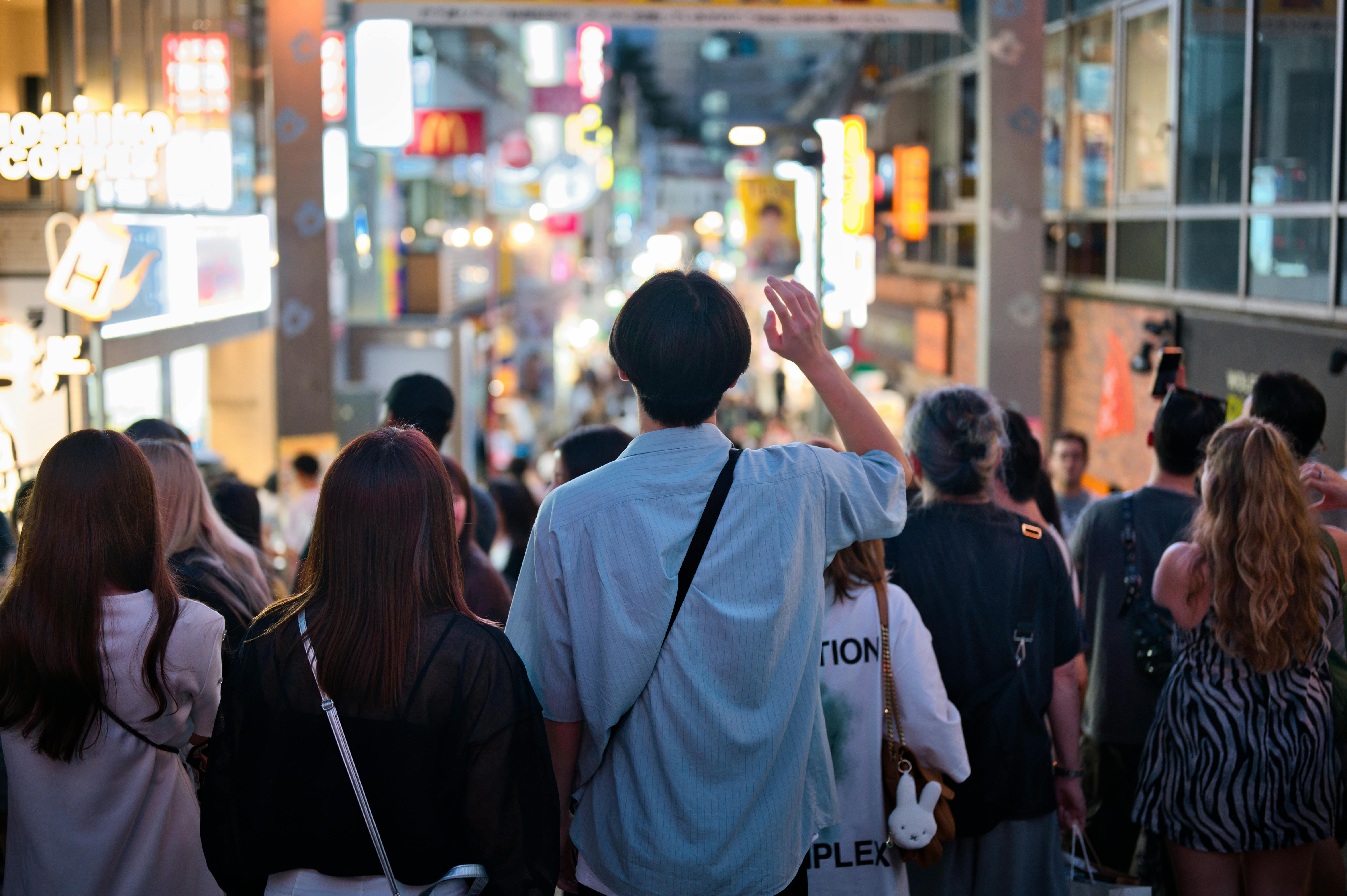 Vibrant night scene of a crowded street in Tokyo, Japan, capturing urban life.