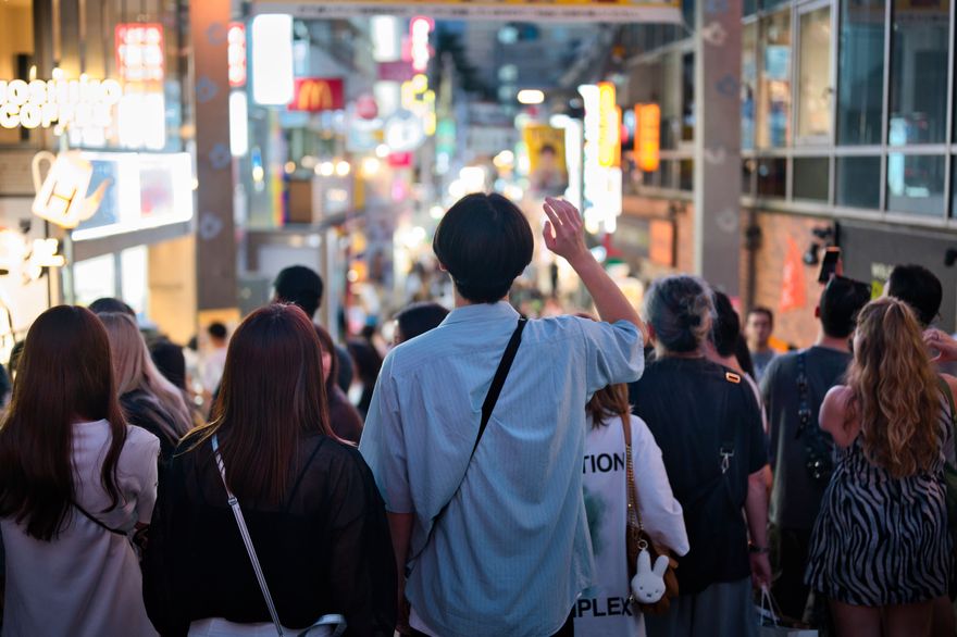 A crowded Tokyo street lit by shopfronts and signage at night — photo by Federico Abis on Pexels