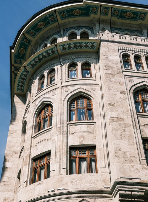 Free Close-up view of a historic building with arched windows and ornate facades, showcasing classic architecture. Stock Photo