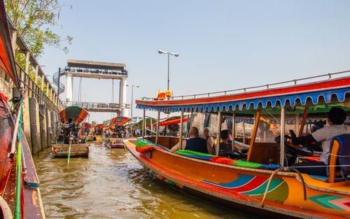 Free Lively canal scene with colorful boats navigating in Bangkok, Thailand. Stock Photo