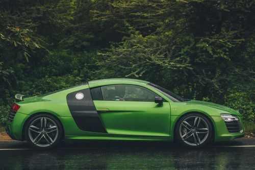 Free Green Audi R8 V10 parked outdoors, showcasing sleek design against lush greenery. Stock Photo