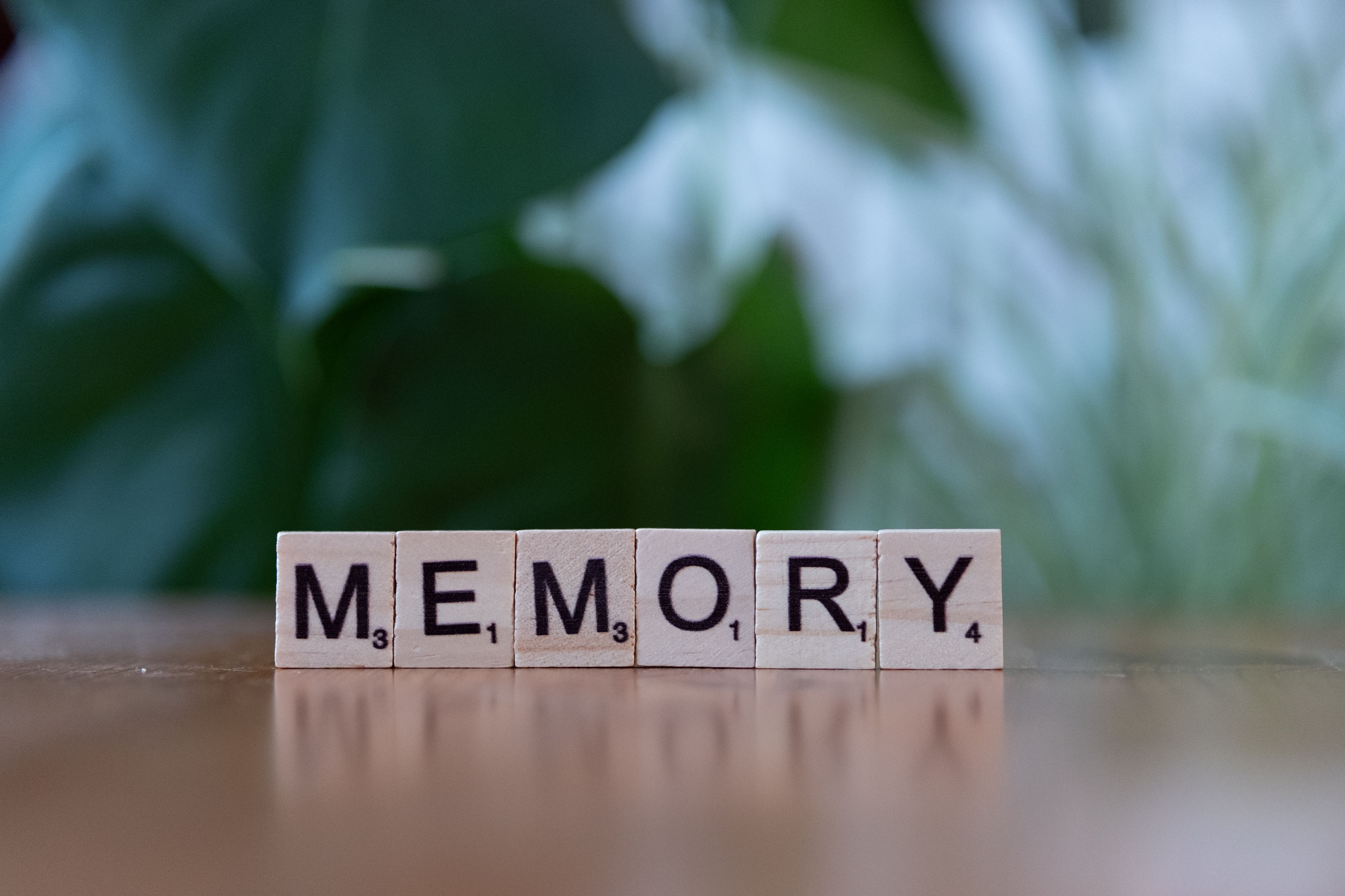 Miễn phí Những ô chữ bằng gỗ đánh vần 'Memory' trên một chiếc bàn gỗ có nền xanh mờ. Ảnh lưu trữ