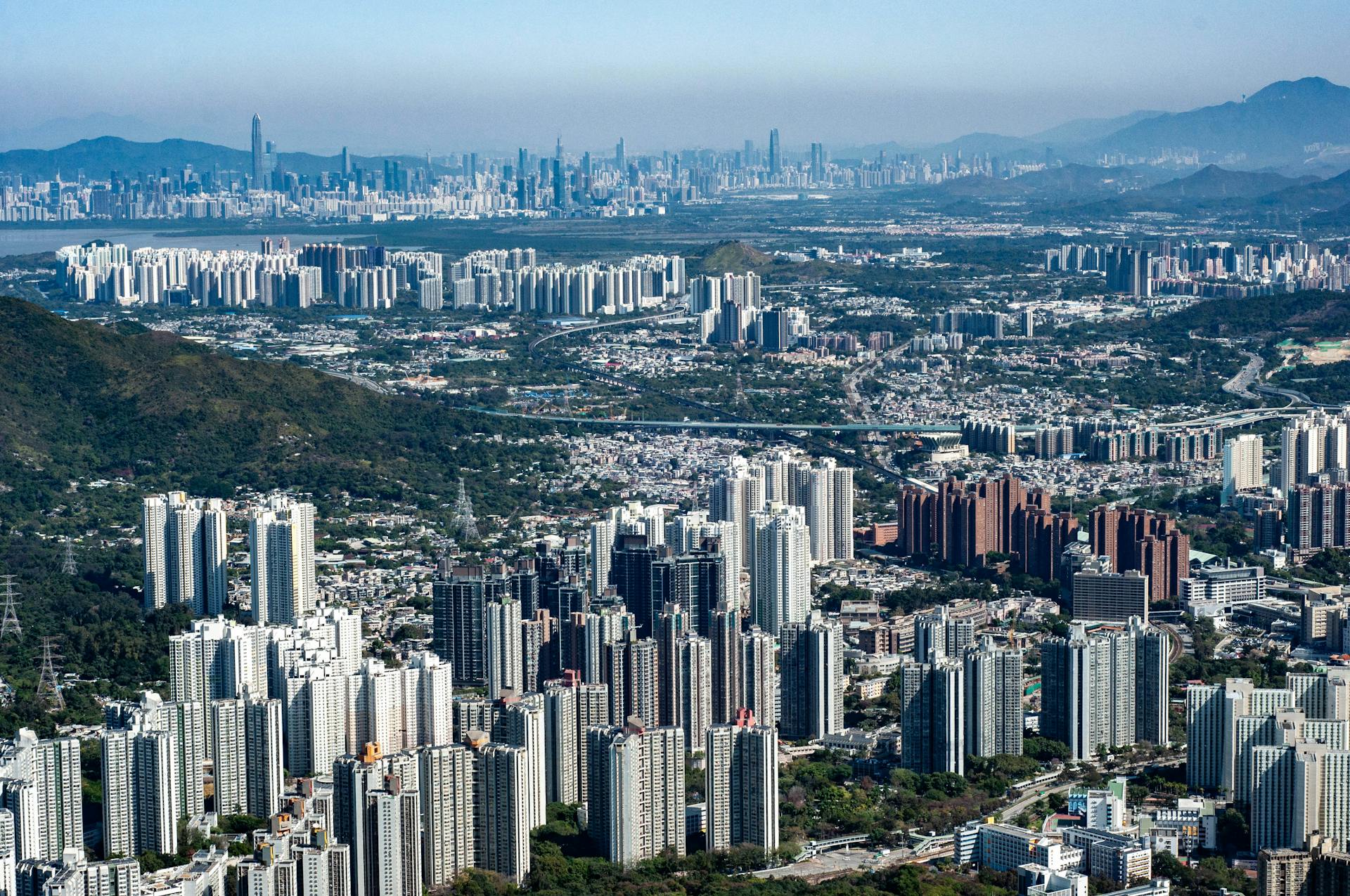 Stunning aerial view of Hong Kong's dense urban landscape with skyscrapers and greenery.