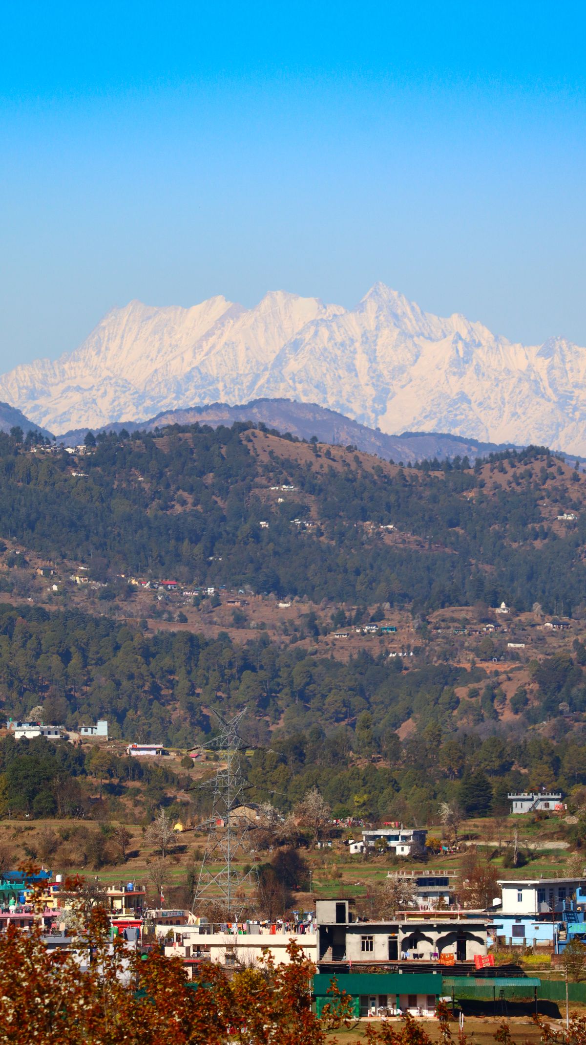 Himalayan snow peaks over a Kumaon hill town near Almora, Uttarakhand
