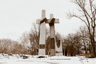 The Poznań Cross Monument on a snowy day captures the historical essence of Greater Poland.