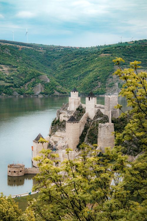 Free Beautiful aerial view of Golubac Fortress next to the Danube River in Serbia, surrounded by lush greenery. Stock Photo