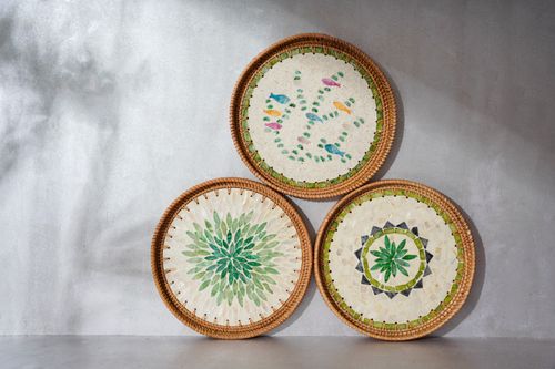 Free Three decorative woven baskets with vibrant botanical and geometric designs against a neutral wall. Stock Photo
