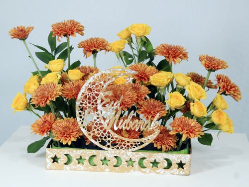 Free Elegant Eid Mubarak floral arrangement featuring yellow roses and orange chrysanthemums. Stock Photo