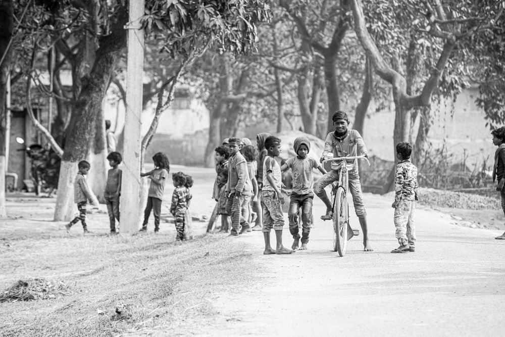Children playing on a village road, photographed in black and white