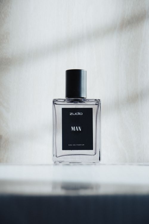 Free Minimalist photo of a men’s perfume bottle against a light background. Stock Photo