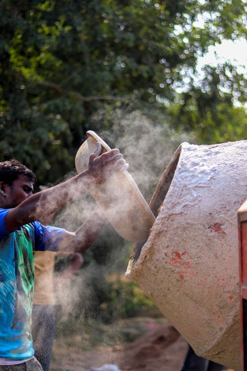 Ethnic man preparing cement for construction