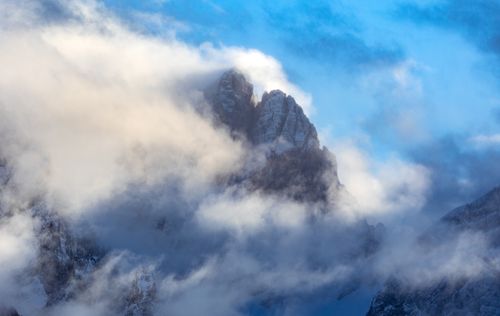 Free Captivating view of mist-covered peaks in the Italian Dolomites, shrouded in clouds. Stock Photo