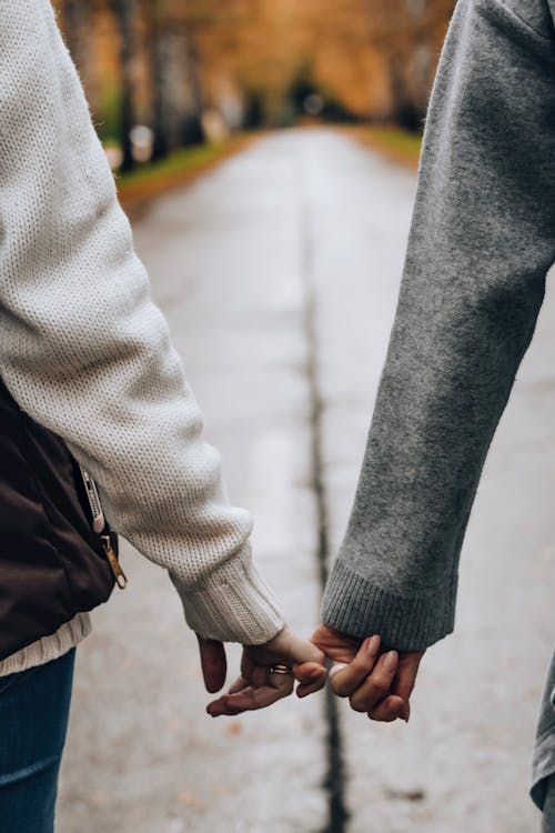Free Photo of Two Persons Holding Hands Stock Photo