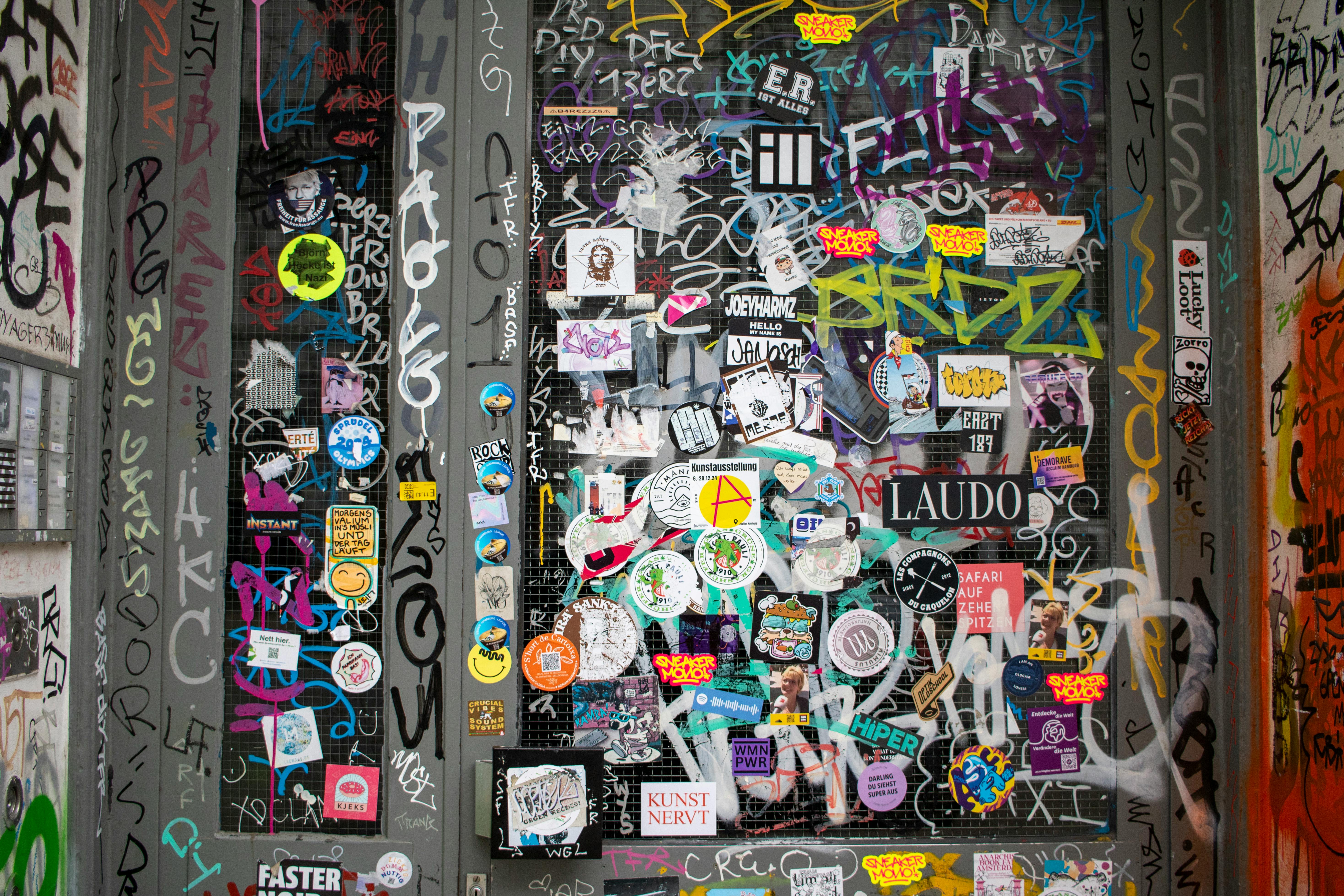 bezplatná Živé graffiti a nálepky pokrývají dveře v Hamburku a představují kulturu pouličního umění. Základová fotografie