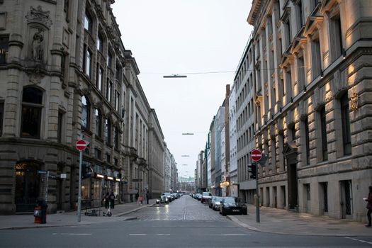 A view of historic buildings on a quiet street in Hamburg, Germany, during twilight.