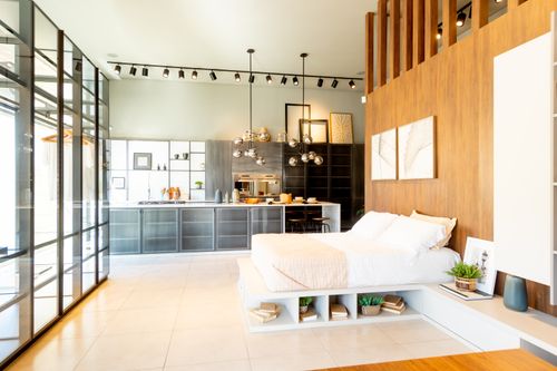 Free Stylish open-plan bedroom and kitchen interior with modern decor and lighting. Stock Photo