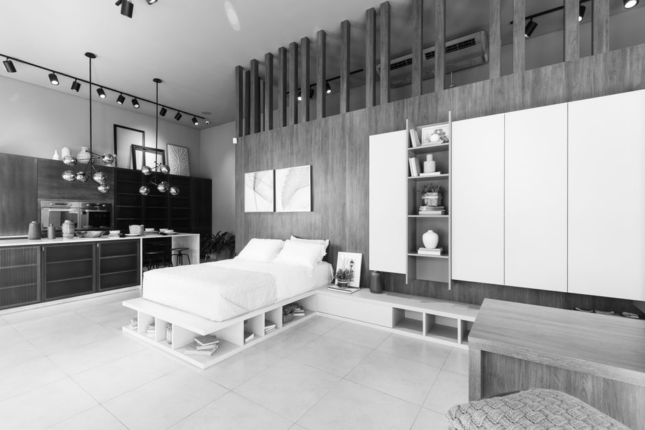 Photo by Jhonny' Mages on Pexels Black and white image of a modern minimalist bedroom with sleek furniture and lighting.