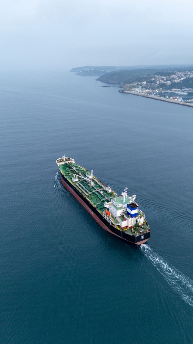 Aerial view of a cargo ship sailing near the coastline