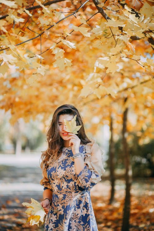 Photo of Woman Covering Her Face With Leaf