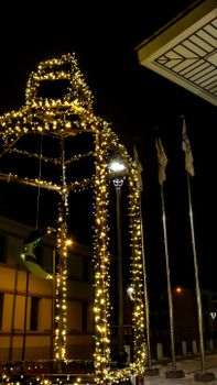 A beautifully lit gazebo adorned with lights in an urban night setting, perfect for festive occasions.