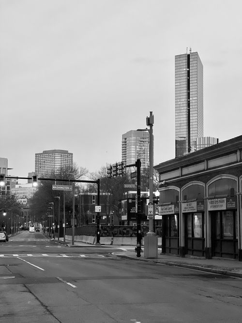 Free Monochrome view of a city street with modern skyscrapers in the background. Stock Photo