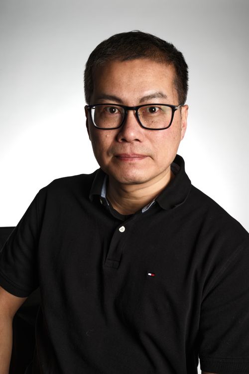 Free Studio portrait of an adult man wearing glasses and a black shirt against a neutral background. Stock Photo
