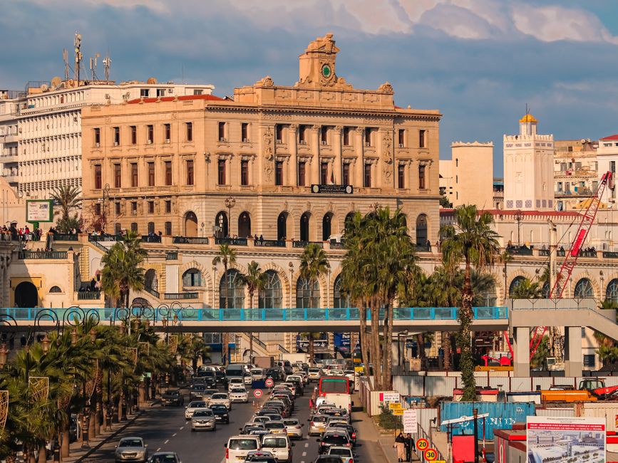 High-angle view of Algiers features bustling traffic, historic architecture, and vibrant city life.