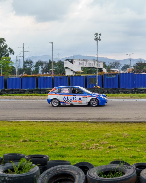 Exciting Car Race on Outdoor Track with Blue Car · Free Stock Photo