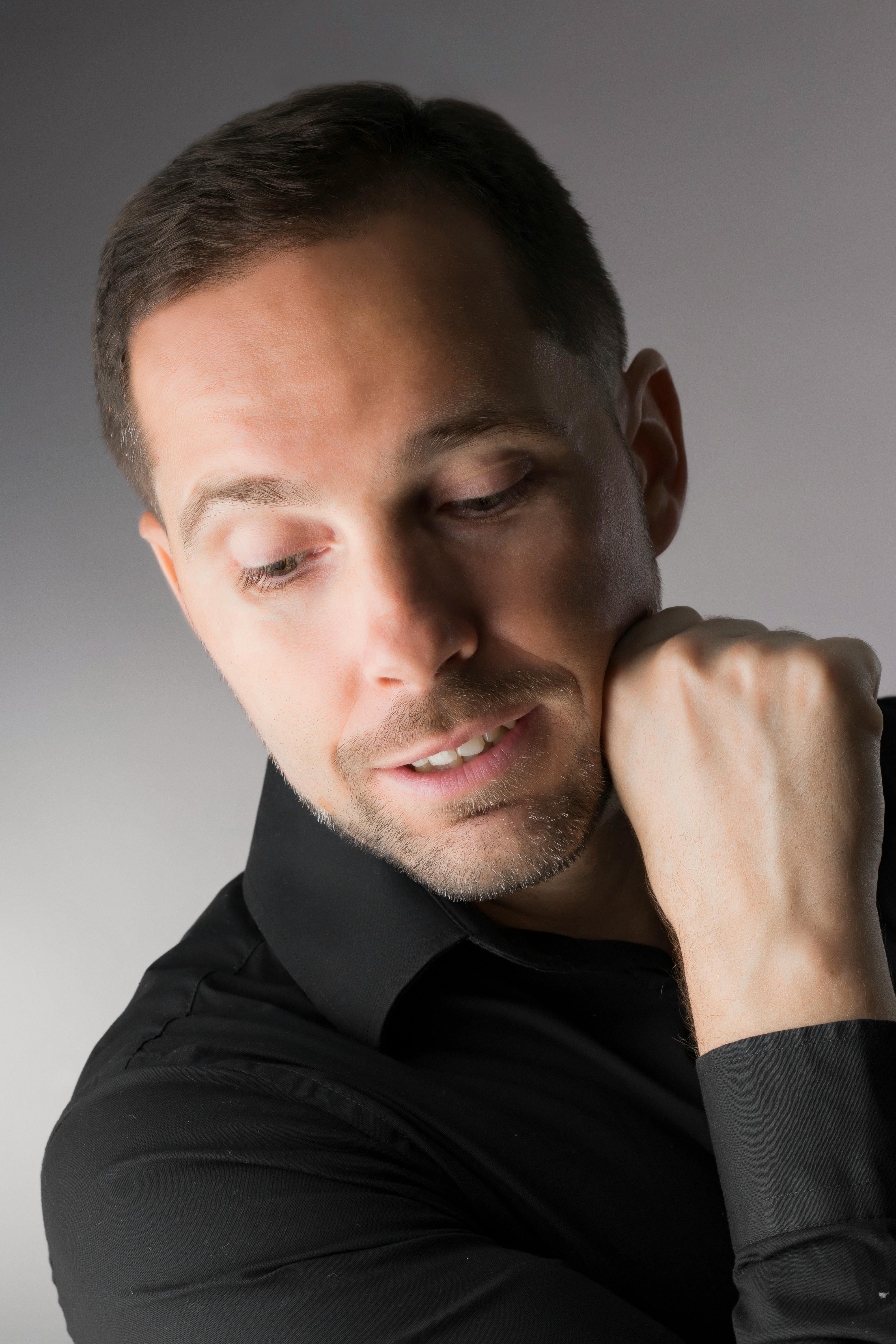 Studio portrait of a man in formal attire, exuding calm elegance.