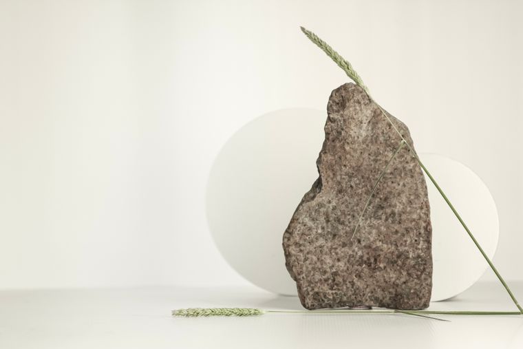 Stone and grass blades in a minimal composition — Photo by Karen Laårk Boshoff on Pexels